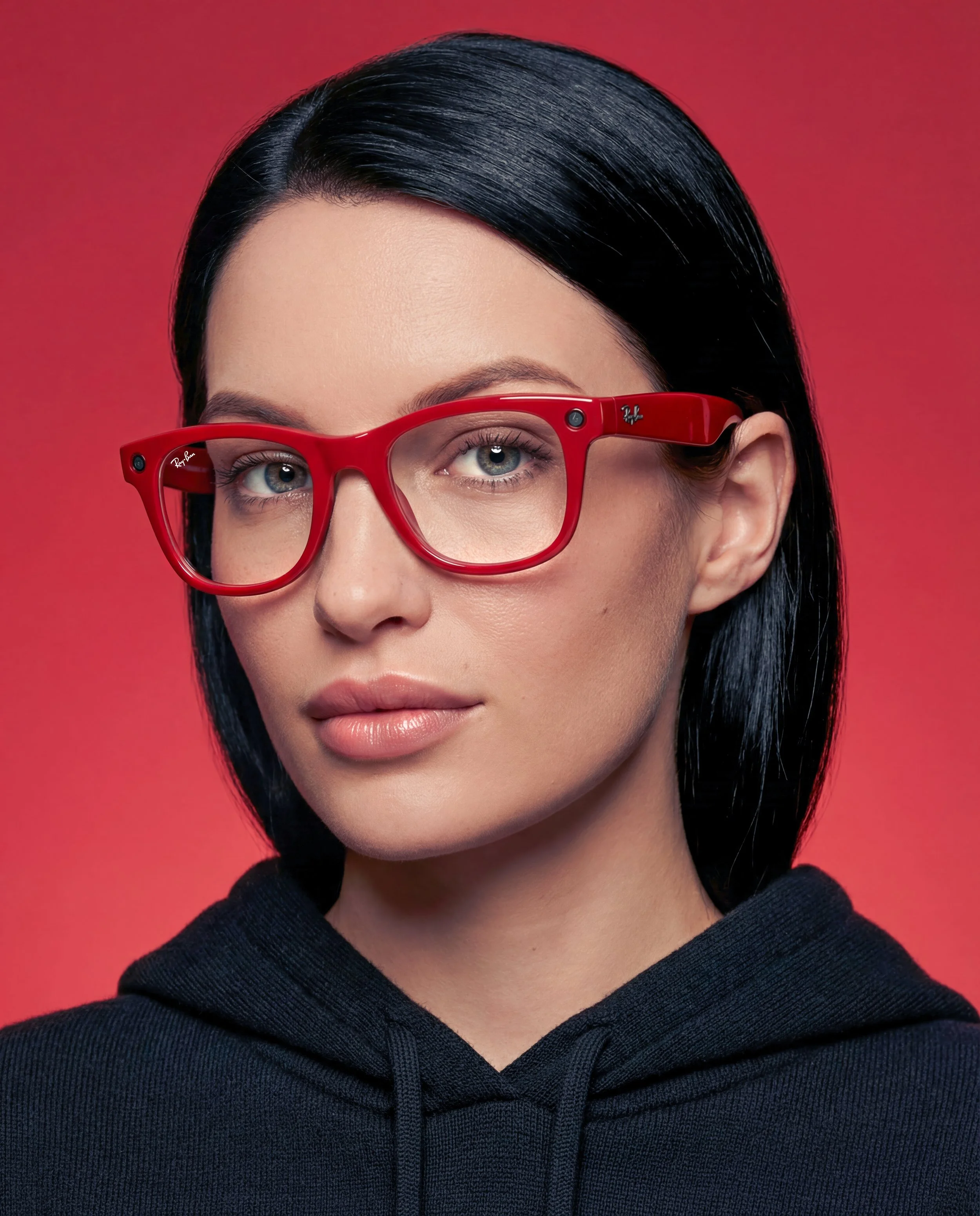 Professional studio headshot featuring Meta Ray-Ban smart glasses on a red backdrop, created with advanced AI tools for user-generated product photography.