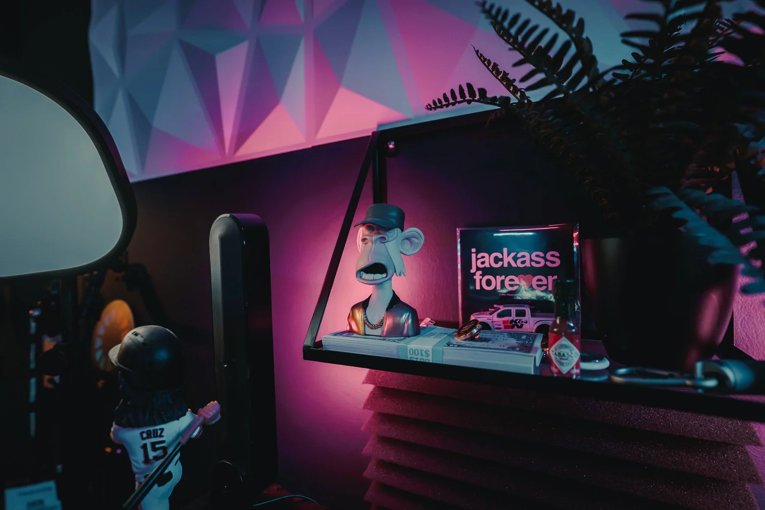 Studio shelf detail with colorful lighting and collectibles in Ian Jones' Pittsburgh office