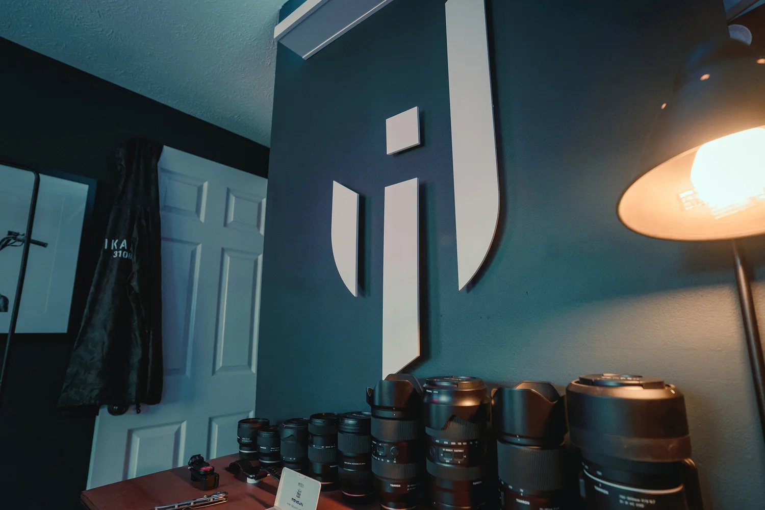 Tamron lenses displayed under ISJ wall mark in Pittsburgh photography studio