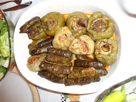 Garlic yogurt with sauteed eggplant and peppers, drizzled with olive oil