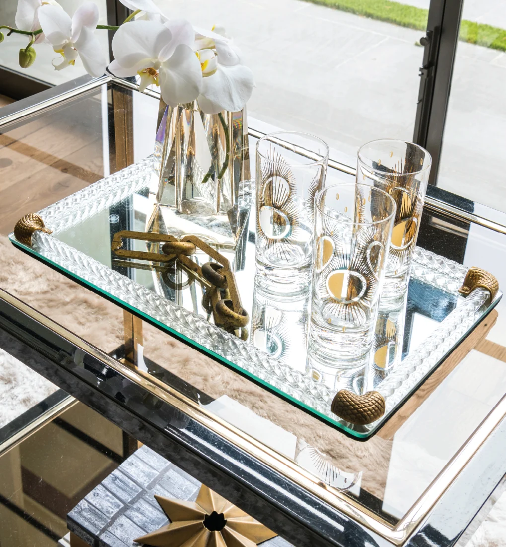 Vintage barware and bar cart mixed on modern day tray invites your guests to relaxin in your home. Photo by Michael Hunter