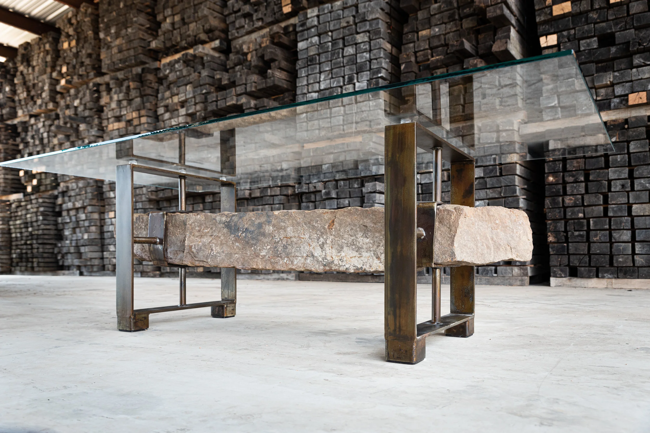 Photo by Ashlee Nobel This table is the perfect example of the juxtaposition of stone, metal and glass.