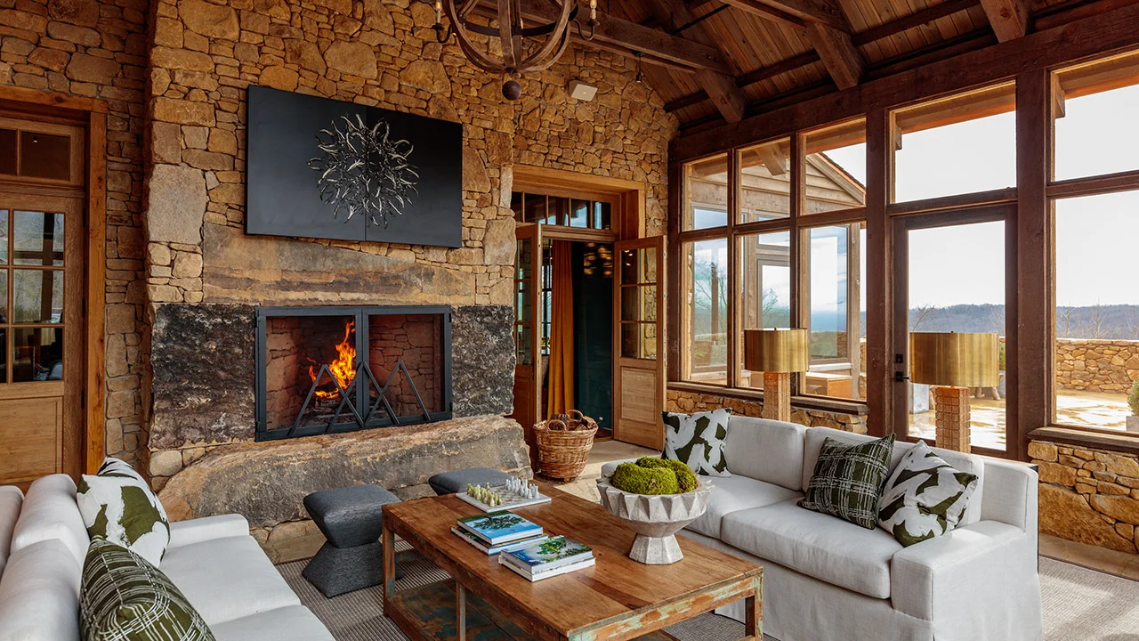 Photo by The Ingalls Lodge screen porch with custom outdoor upholstery, custom TV screen by artist Mitchell Lonas, indoor outdoor carpet from Stark, and cocktail table from McLarens in Round Top.