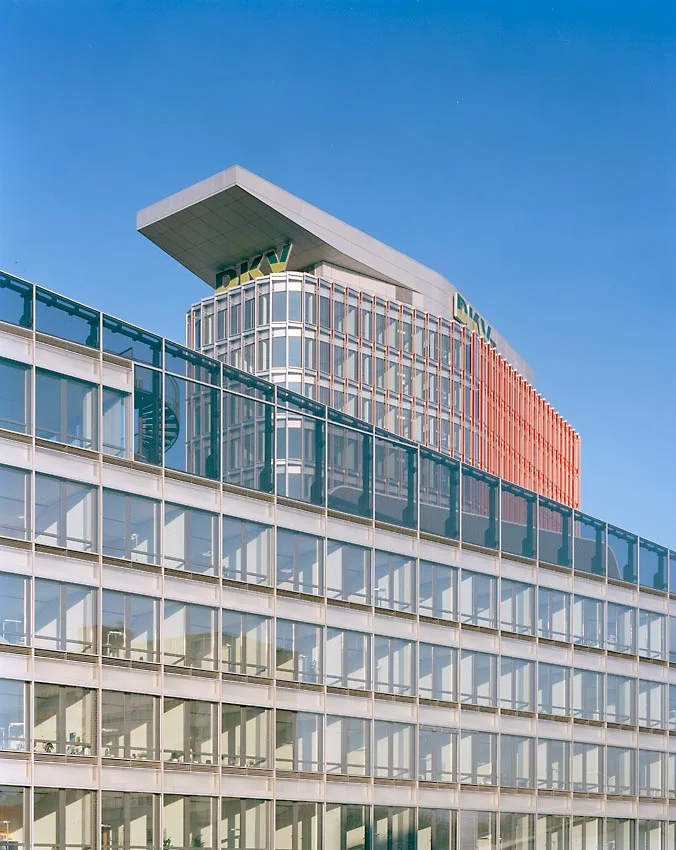 Im Norden bildet der 14-geschossigen Turm, von den Riegeln flankiert, den Abschluss des Ensembles. Niedrige, quer verlaufende Gebäudeteile verbinden die Bürotrakte.
