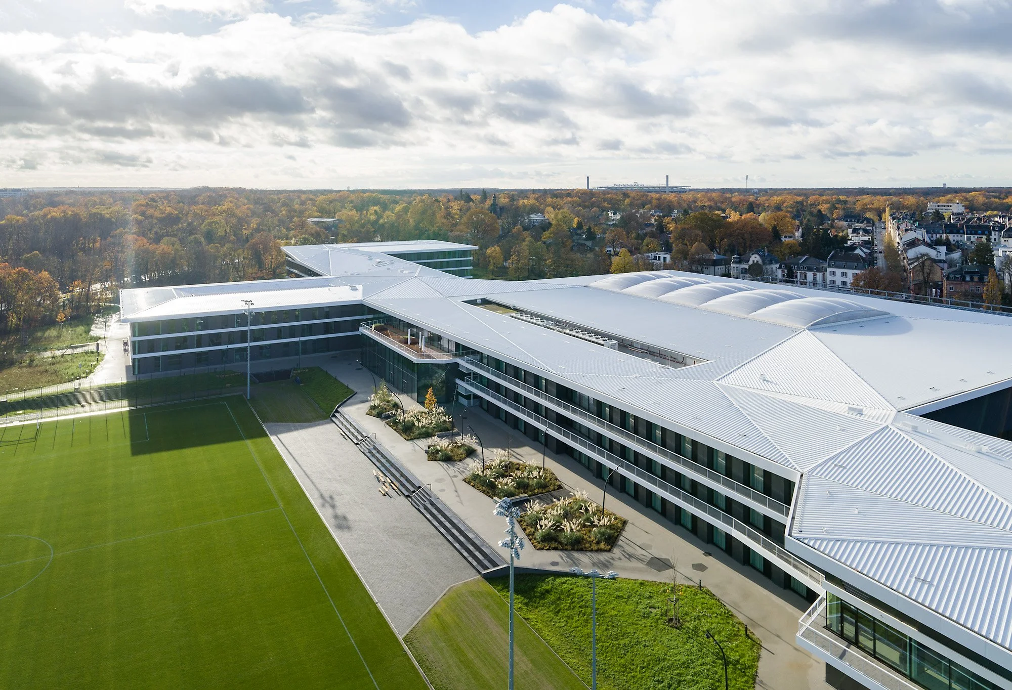  Weiße Fassadenbänder verbinden die Funktionsbereiche. 