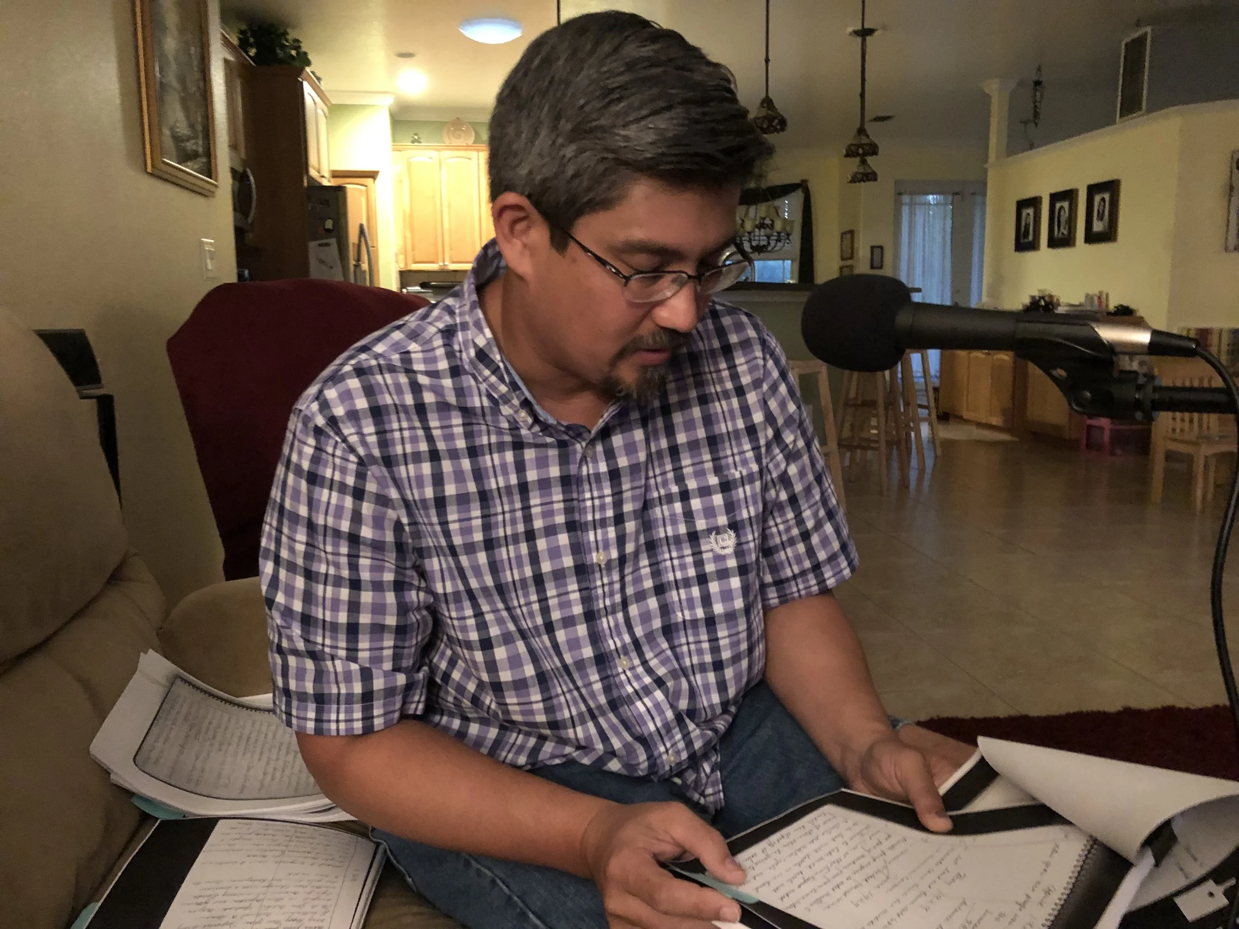 Sage Kamiya reads translated copies of his great grandfather’s journal in his home in Bradenton, Florida. Photo by Alyssa Ramos.