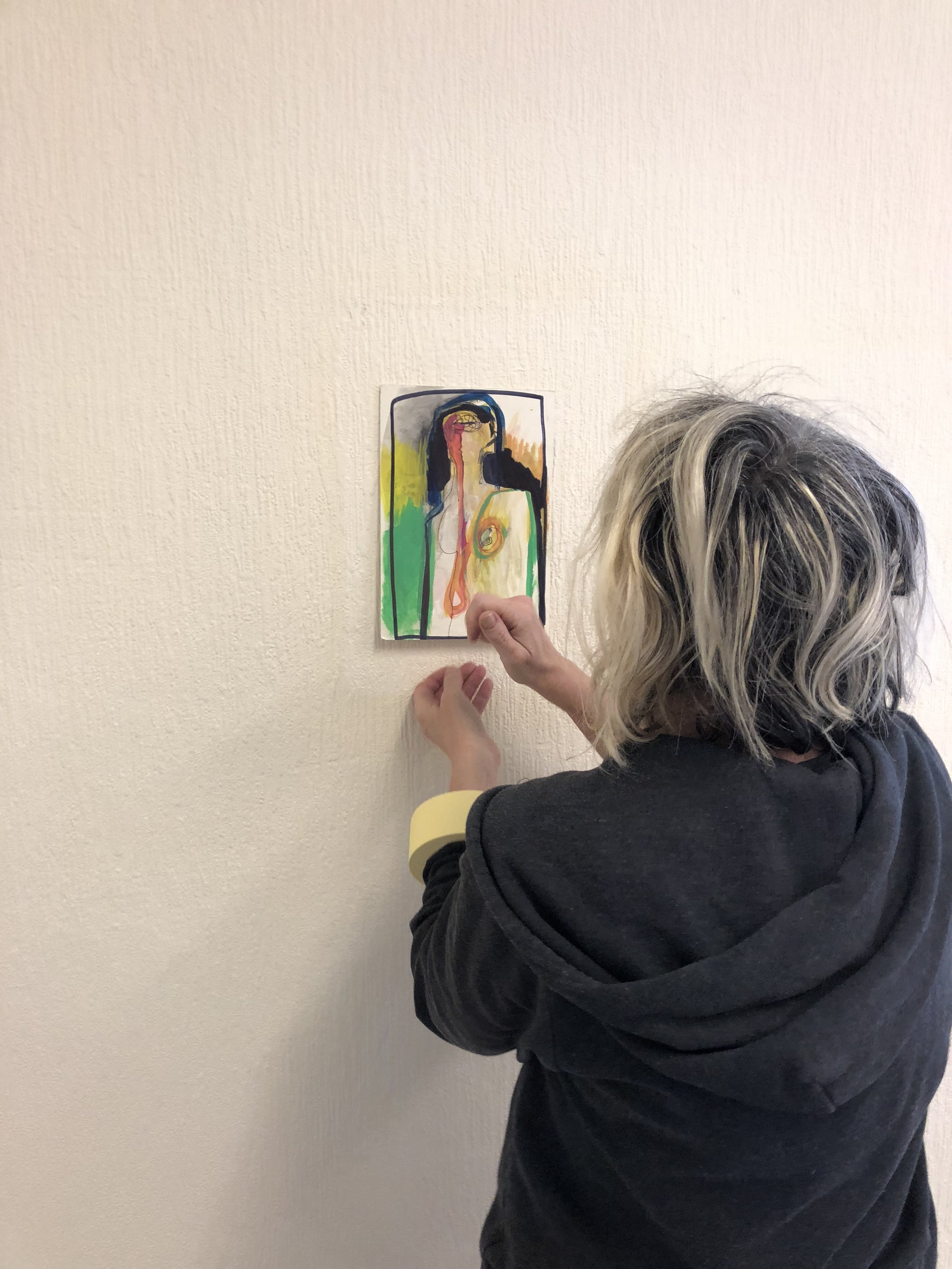  TOMAssociate Emma Mills pinning up an artwork whilst on residency at The Arthouse in Wakefield 