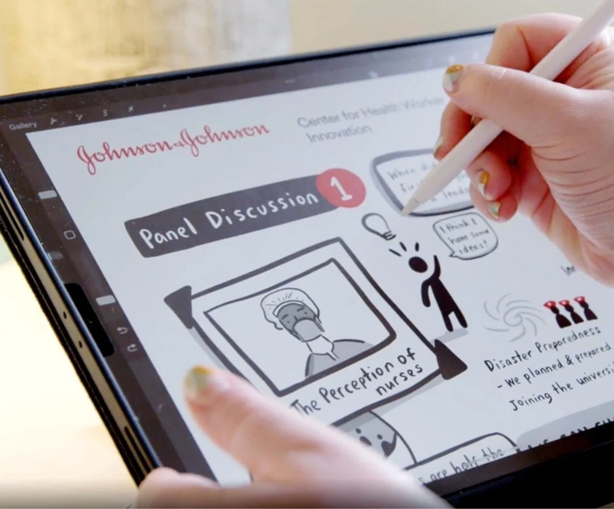hire a live illustrator - conference artist - live illustration - drawing on an iPad at a meeting for Johnson & Johnson