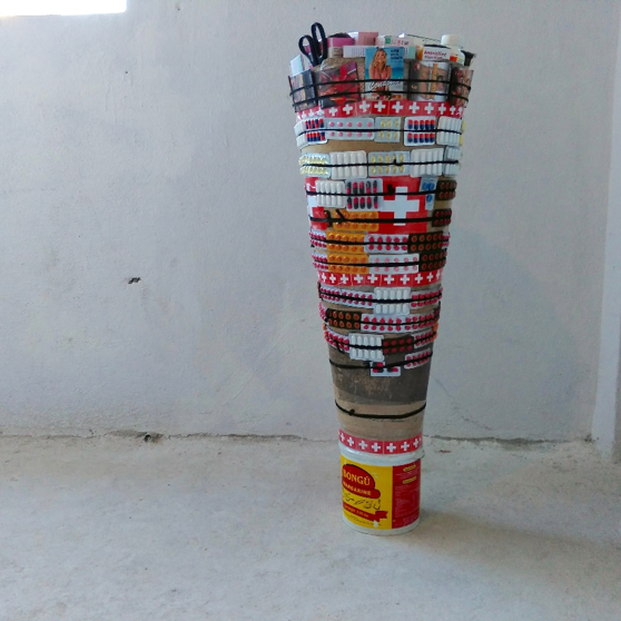 Lafleur & Bogaert, Famasi Mobil Kongolè , 2018, Electric lights, Congo Blue filter sheets, hand painted cardboard, plastic buckets, multicolored pills, rubber bands and pairs of scissors, Approx. 50 x 8 x 15 inches, Courtesy of the artists