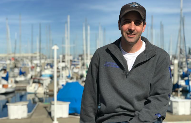Fisherman Scott Fosmark sits on a railing in front of the Monterey Municipal Marina. With deep roots in Monterey's fishing heritage, he hopes the new fish hub can restore the area's local fish supply chain. ERIKA MAHONEY