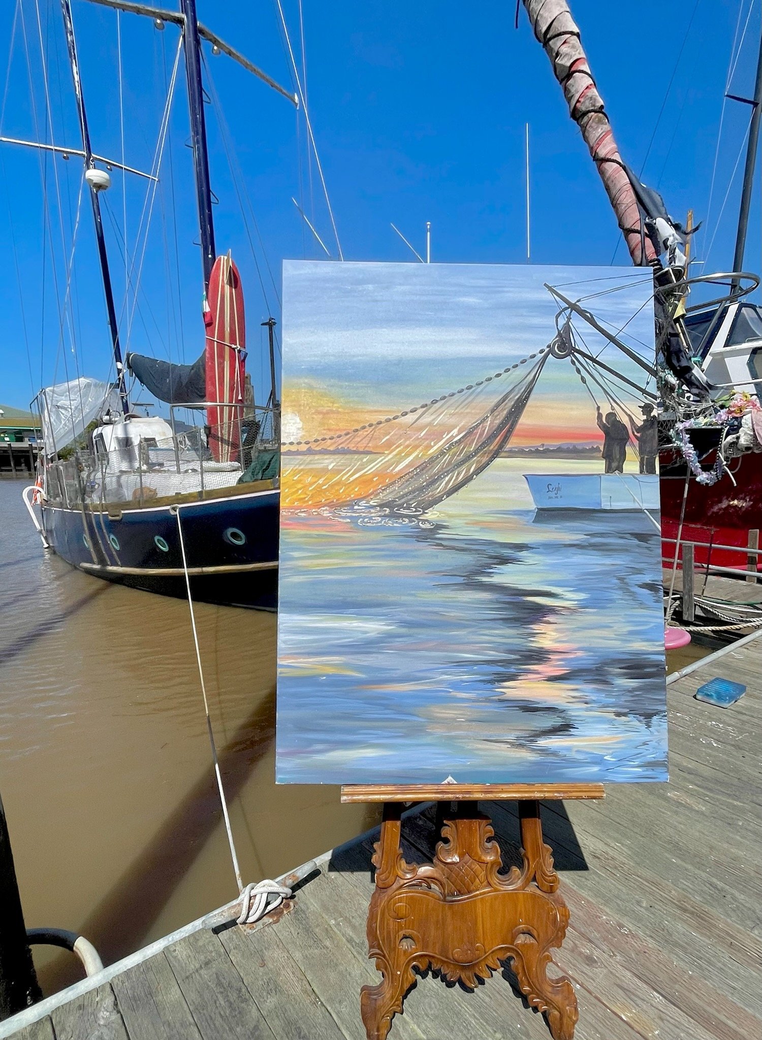 Image of Rick's Boat Yard woman painting boat