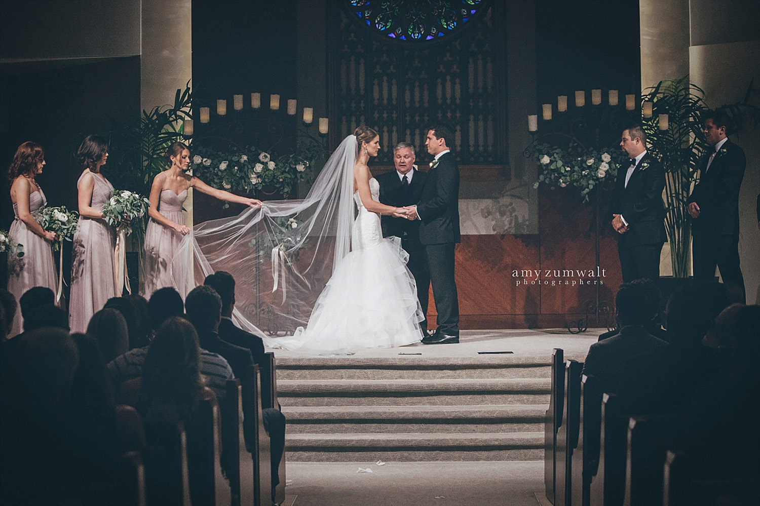 Dallas Baptist Church wedding altar with two large candelabras with greenery