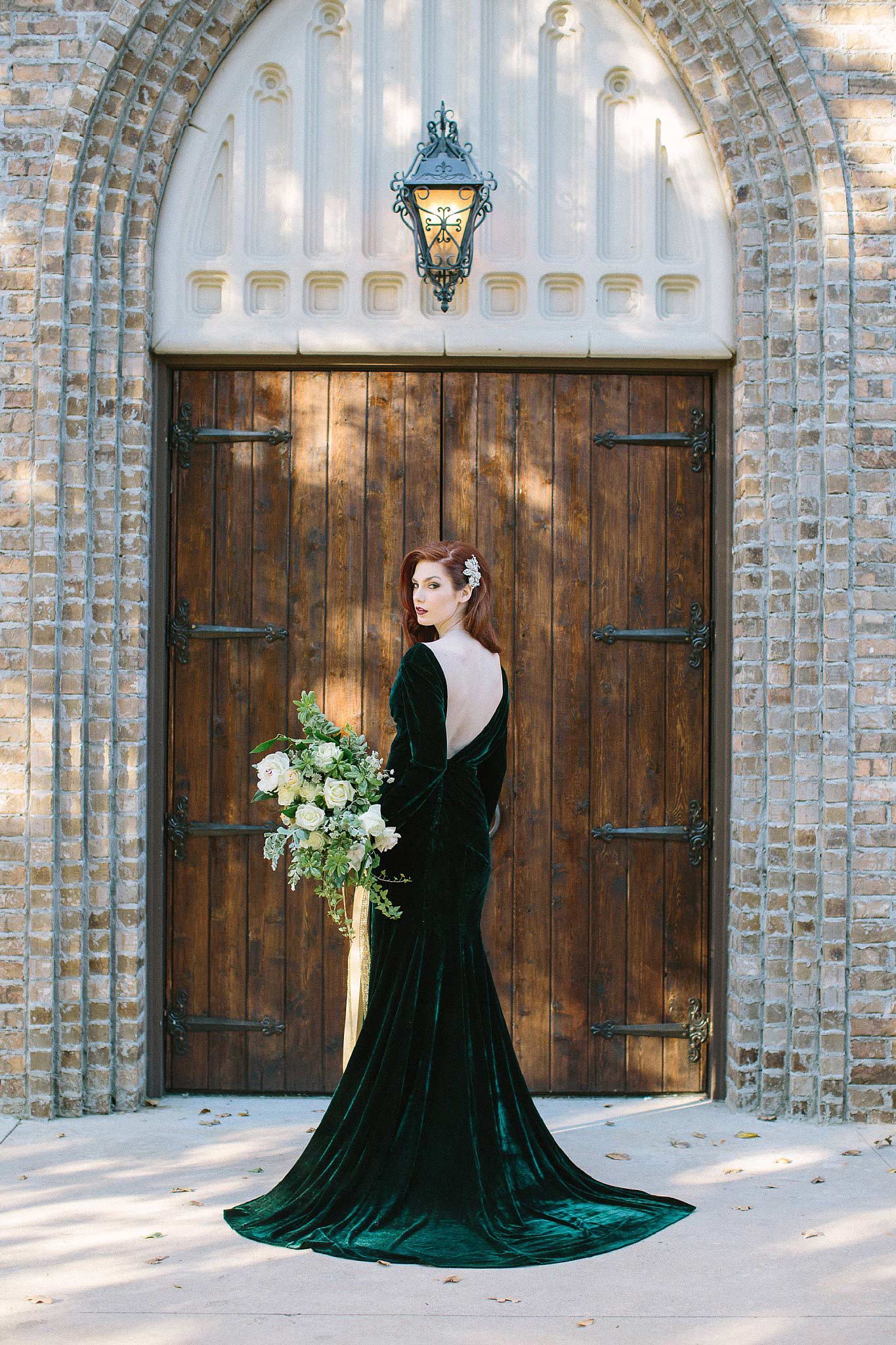 aristide mansfield wooden door entry with bridesmaid in green velvet dress