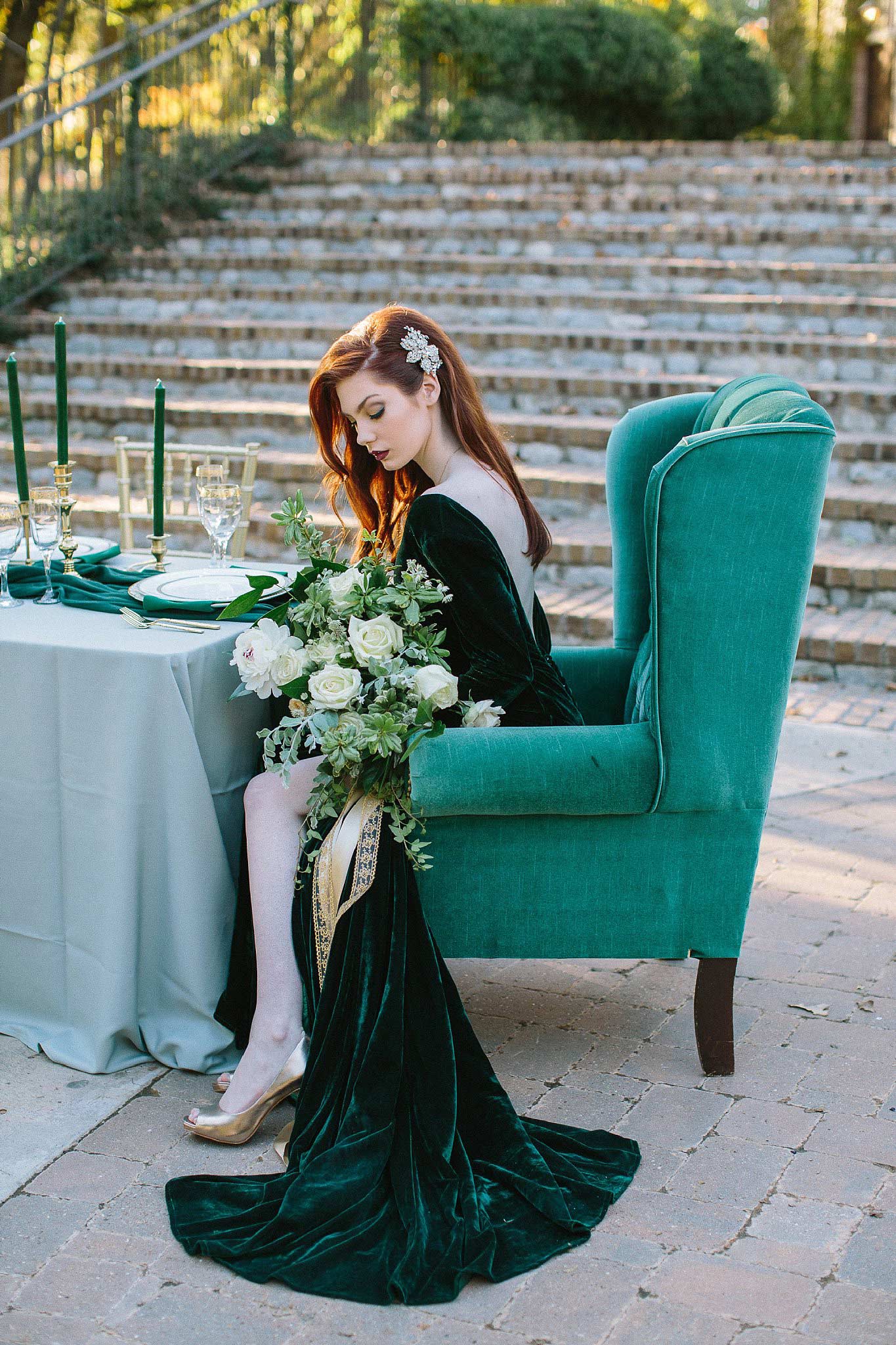 aristide mansfield wedding bridesmaid with green dress sitting at vintage green chair