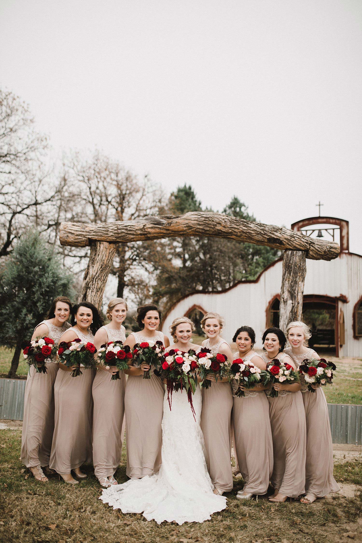 Hollow Hill Farm Event Center Wedding taupe bridesmaid dresses with white and red bouquets