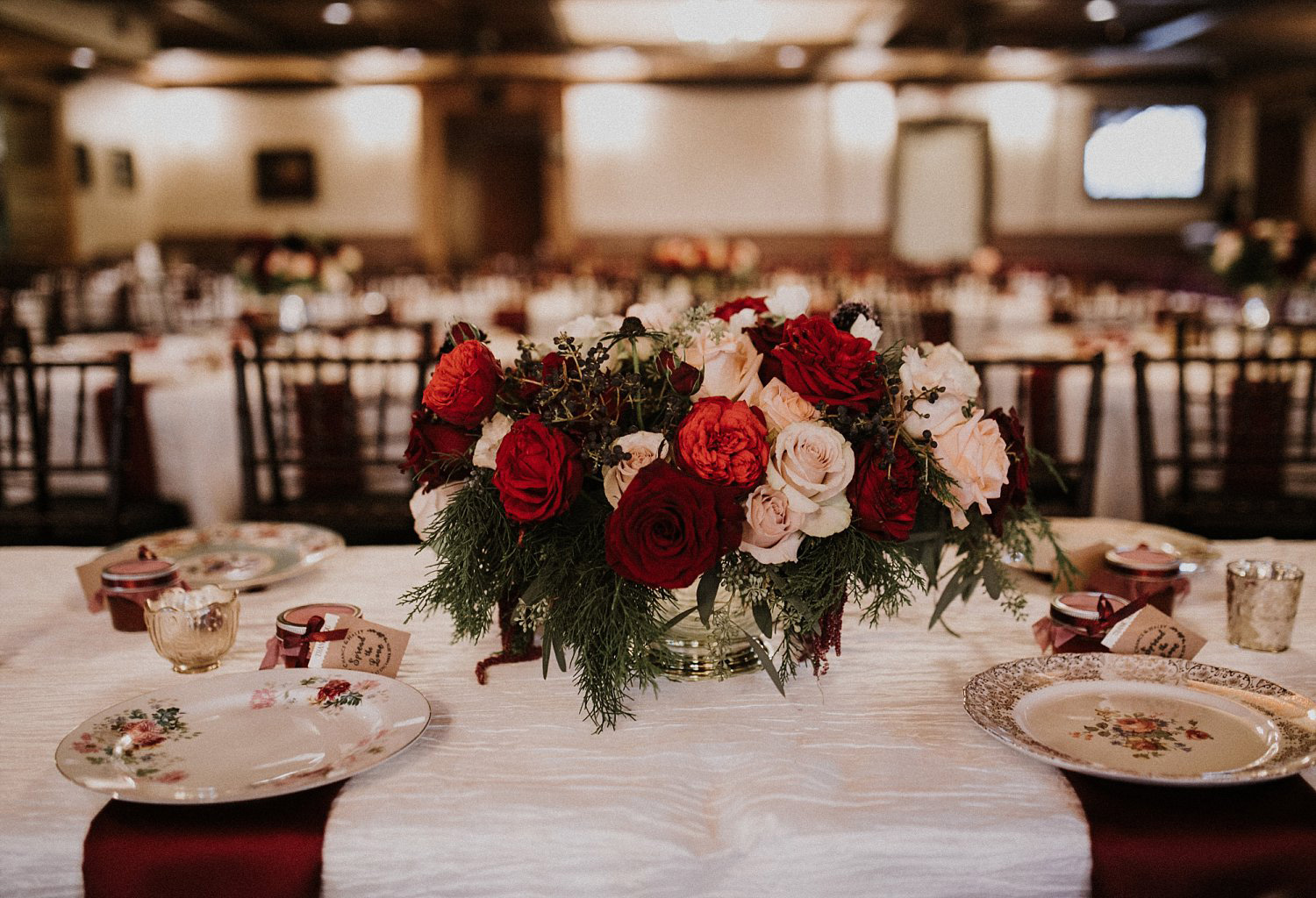 Hollow Hill Farm Event Center Wedding red and cream floral centerpiece with evergreens and berries