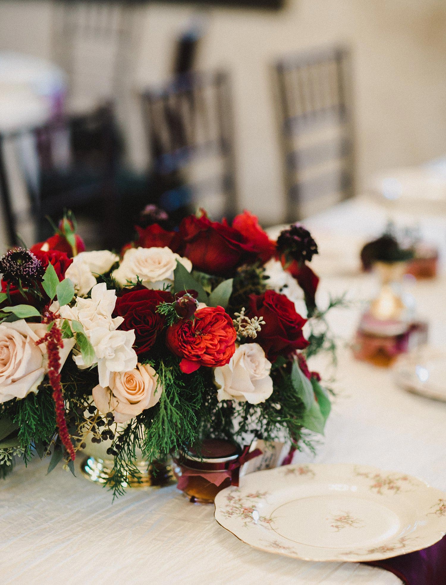 Hollow Hill Farm Event Center Wedding floral centerpiece with red, burgundy and cream roses