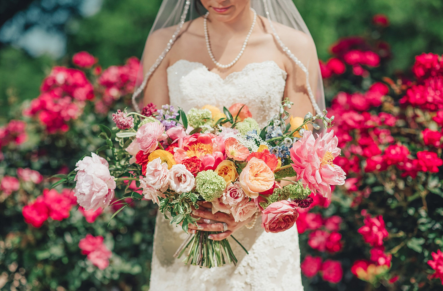The Orchard Azle wedding bride holding colorful bouquet