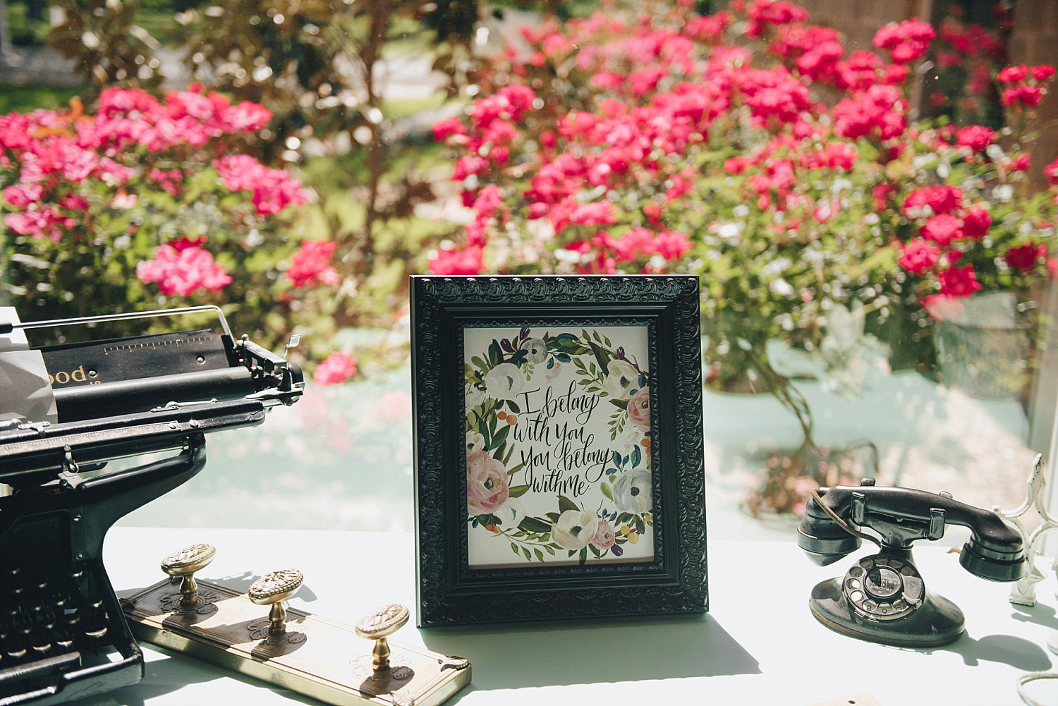 The Orchard Azle wedding floral welcome sign next to typewriter