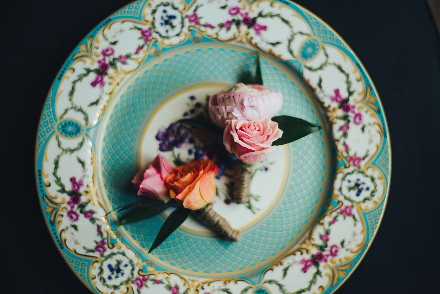 The Orchard Azle wedding boutonniere detail photo on vintage plate