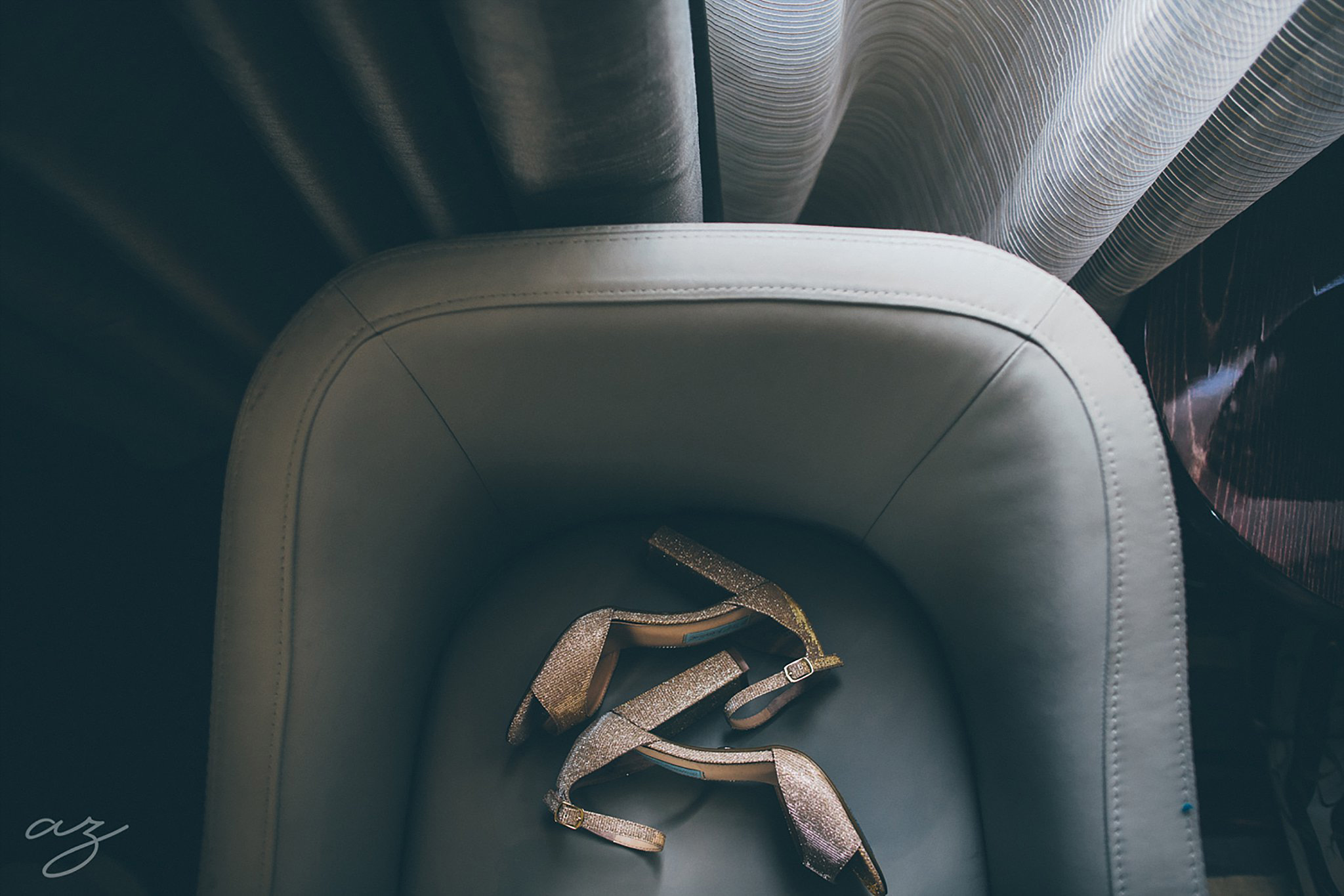 Bridal satin shoes in a leather chair at the Joule Hotel