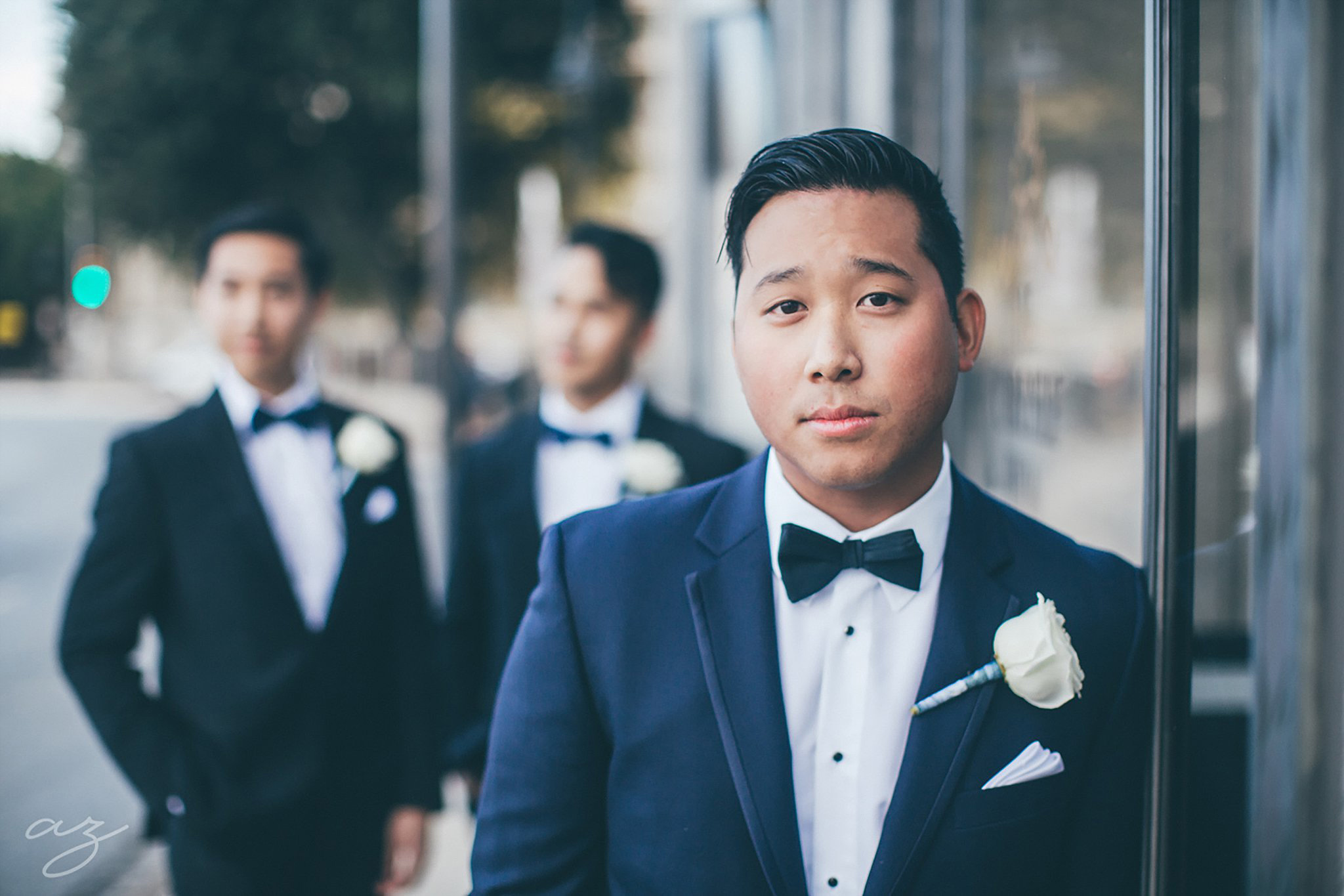 Carlisle Room wedding Groom in grey tux with white boutonniere