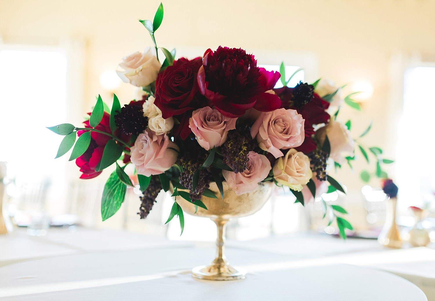 Castle at Rockwall wedding marsala blush and cream flowers in gold vase