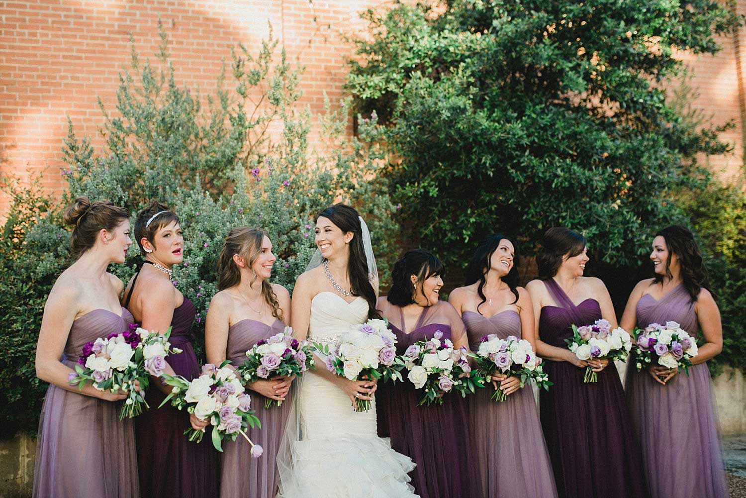 809 at Vickery wedding bridesmaids in lavender and purple bridesmaid dresses in courtyard