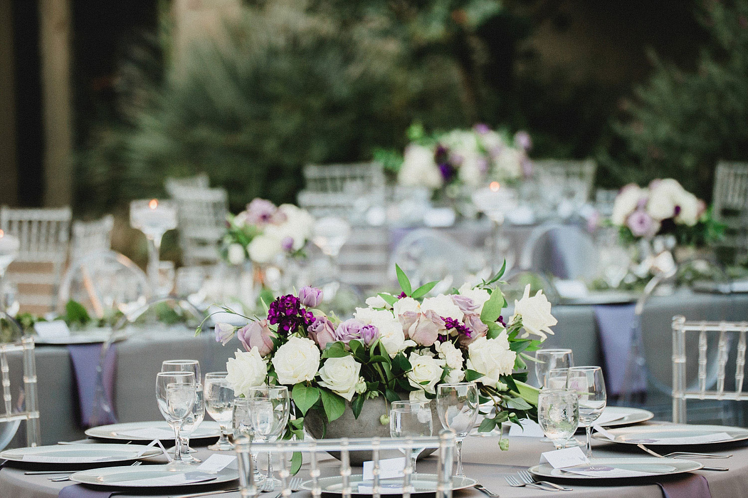 809 at Vickery wedding purple and lavender flowers in concrete boat vases and clear chairs