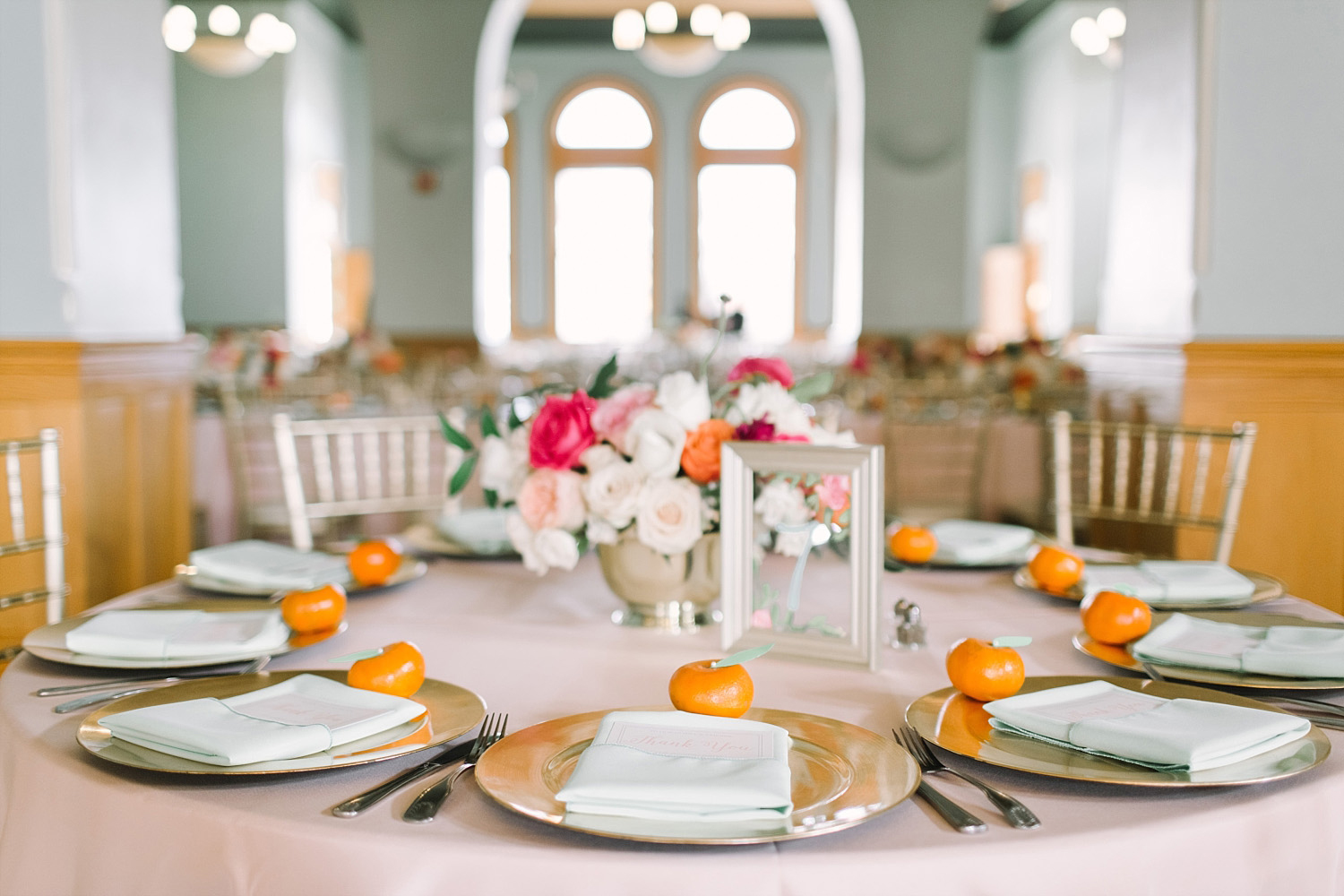 Old Red Museum wedding reception tables with colorful flowers and painted flower table numbers