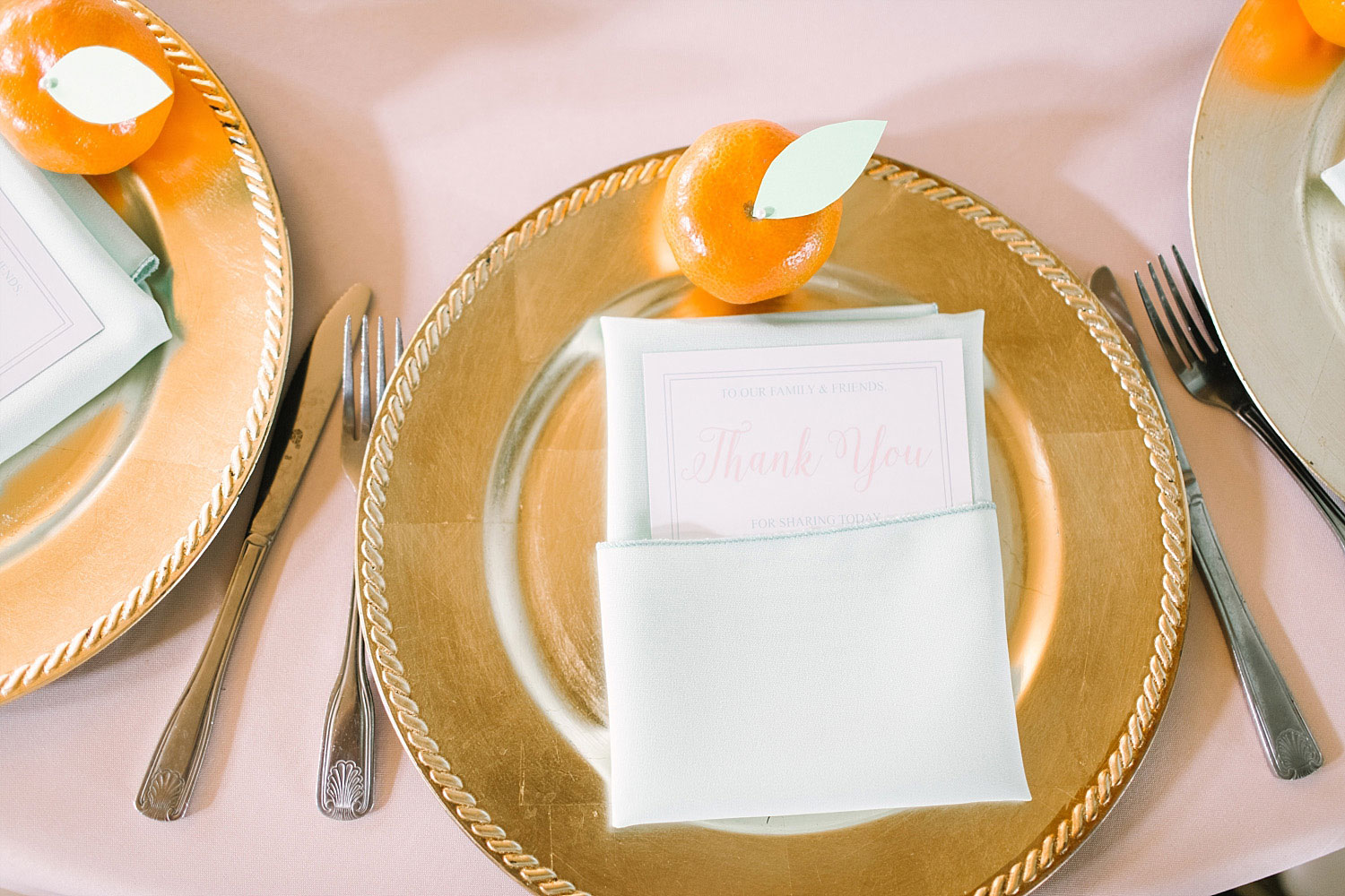 Gold charger place setting with clementine and thank you note at Old Red Museum wedding