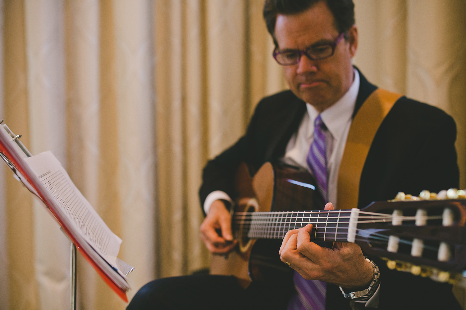 Ceremony musician playing the guitar at a ballroom wedding
