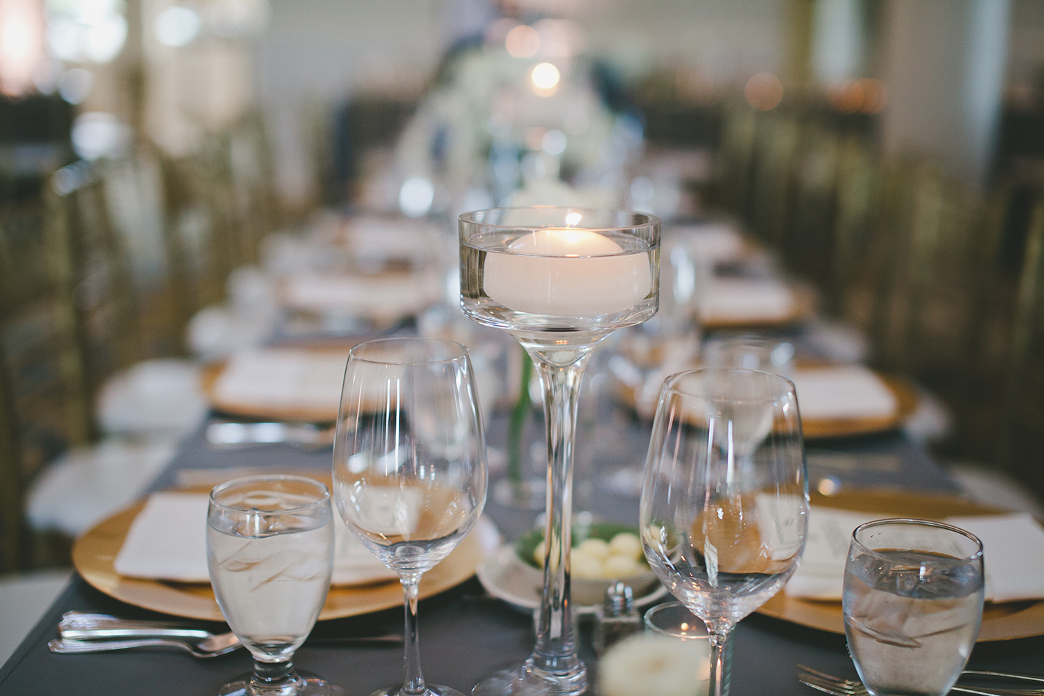 River Crest  country club wedding reception tables with grey linens and floating candles