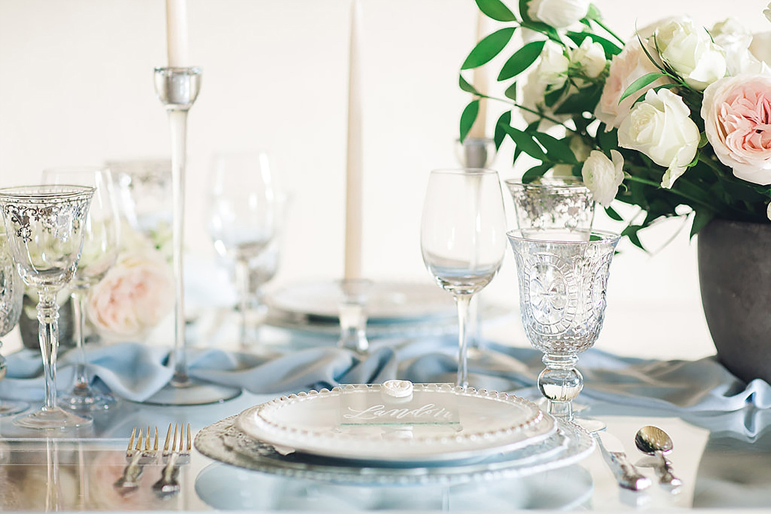 Light blue place setting with a vintage blue charger