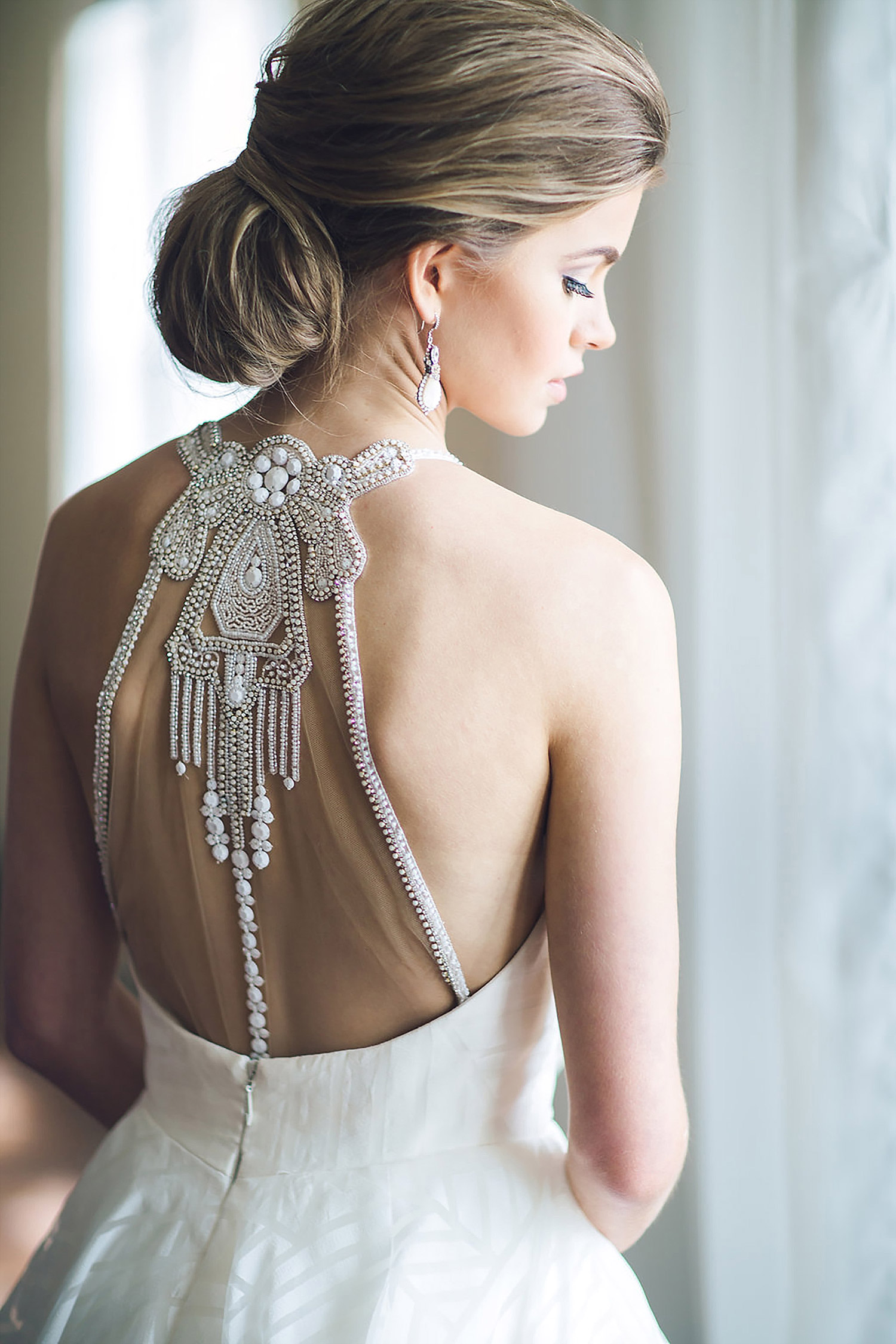 Bride wearing Haley Paige dress with a crystal back with a southern updo