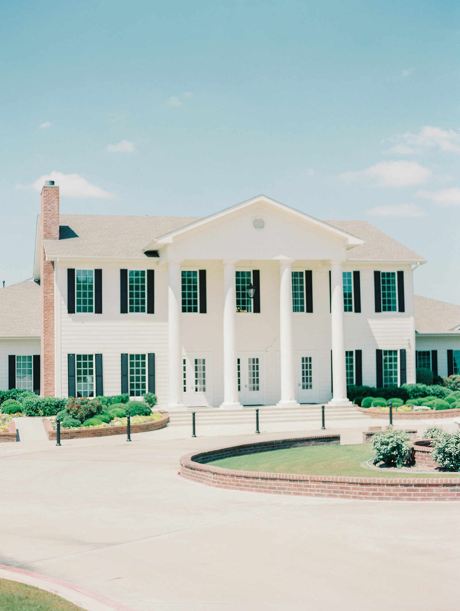 Southern white mansion with black shutters Texas wedding venue The Milestone