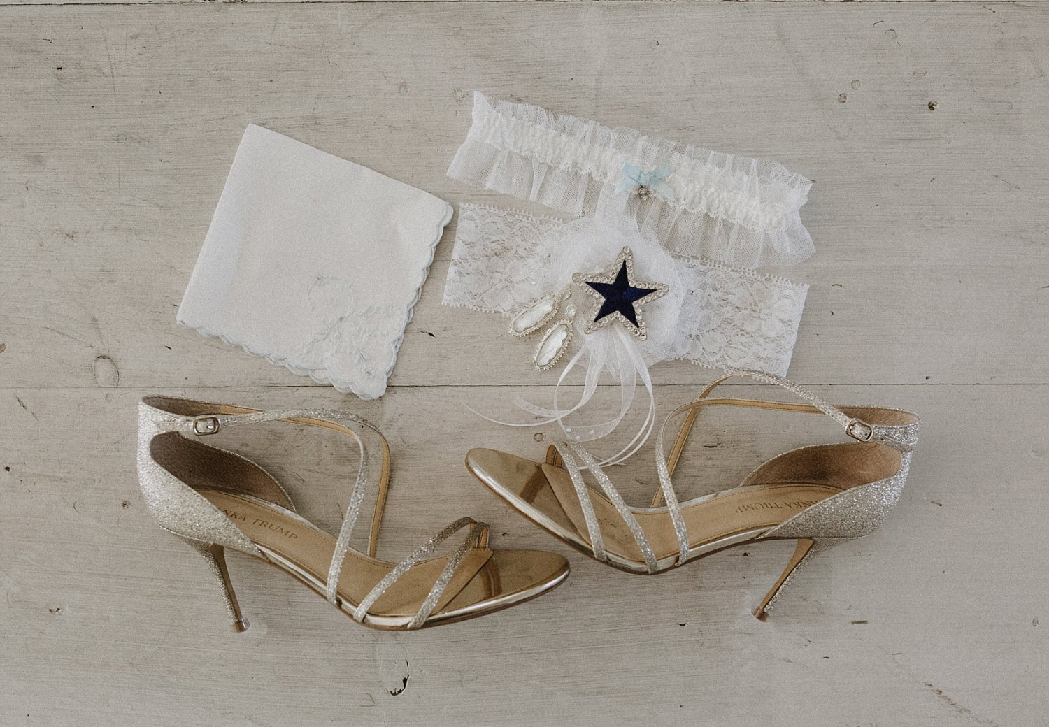 Nude wedding shoes with a dallas cowboy cheerleader garter on white wood floor