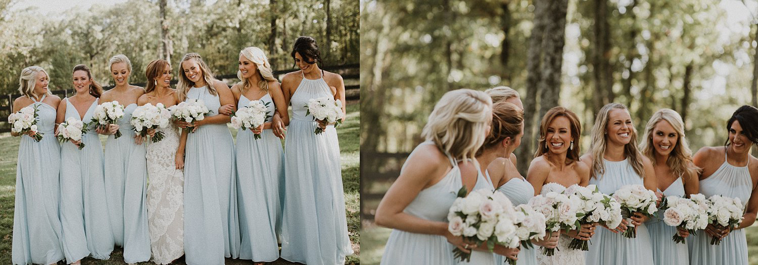 Bridesmaids in long blue bridemaid dresses holding white and blush bridesmaid bouquets at White Sparrow Barn