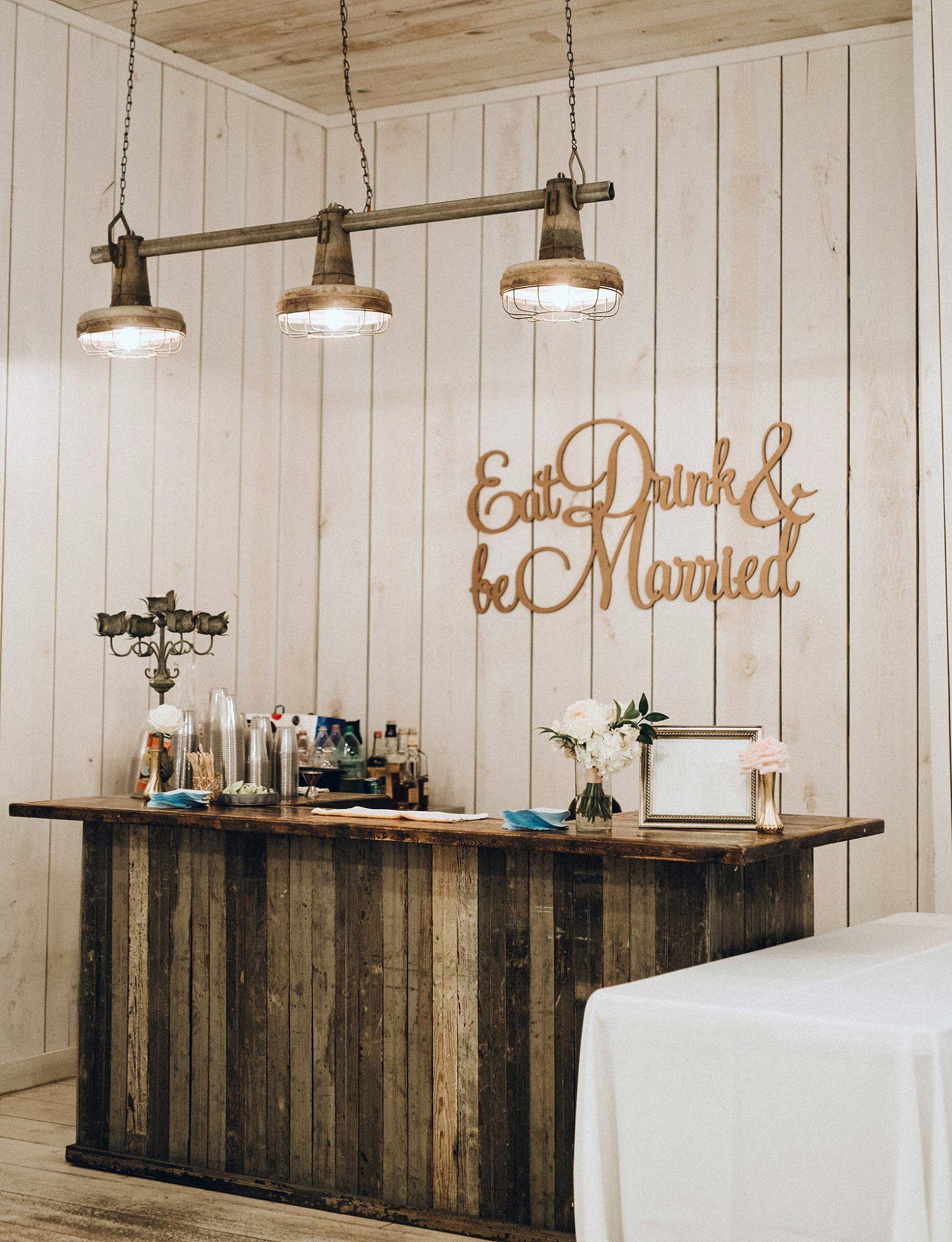 Wood bar with laser cut signage and shiplap walls