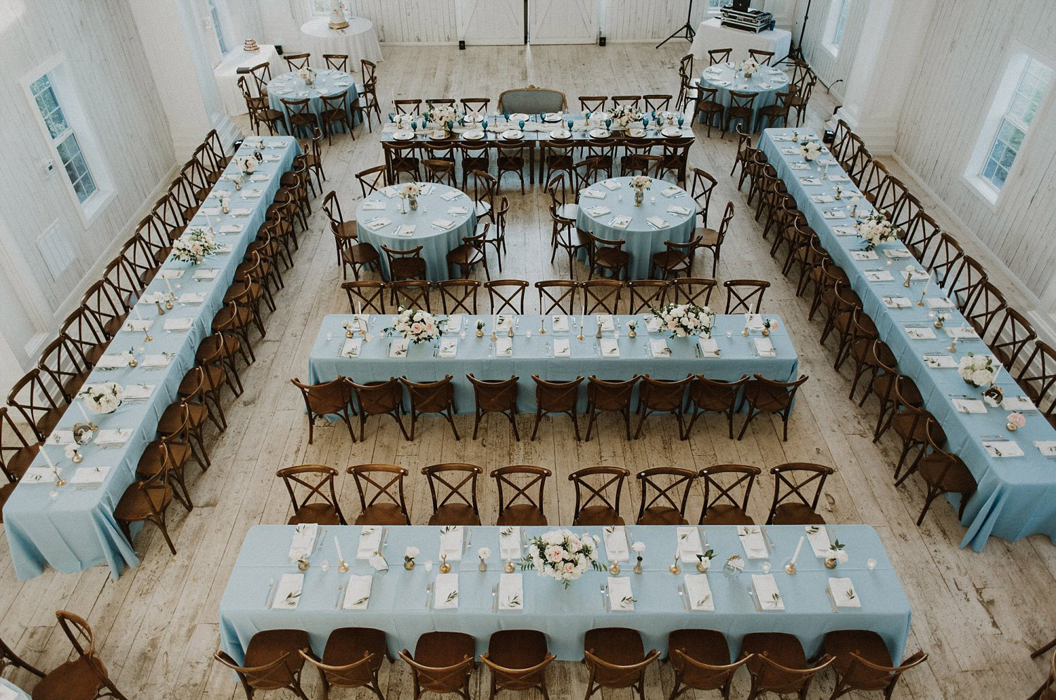 White Sparrow Barn wedding reception with long and round blue tables and dance floor