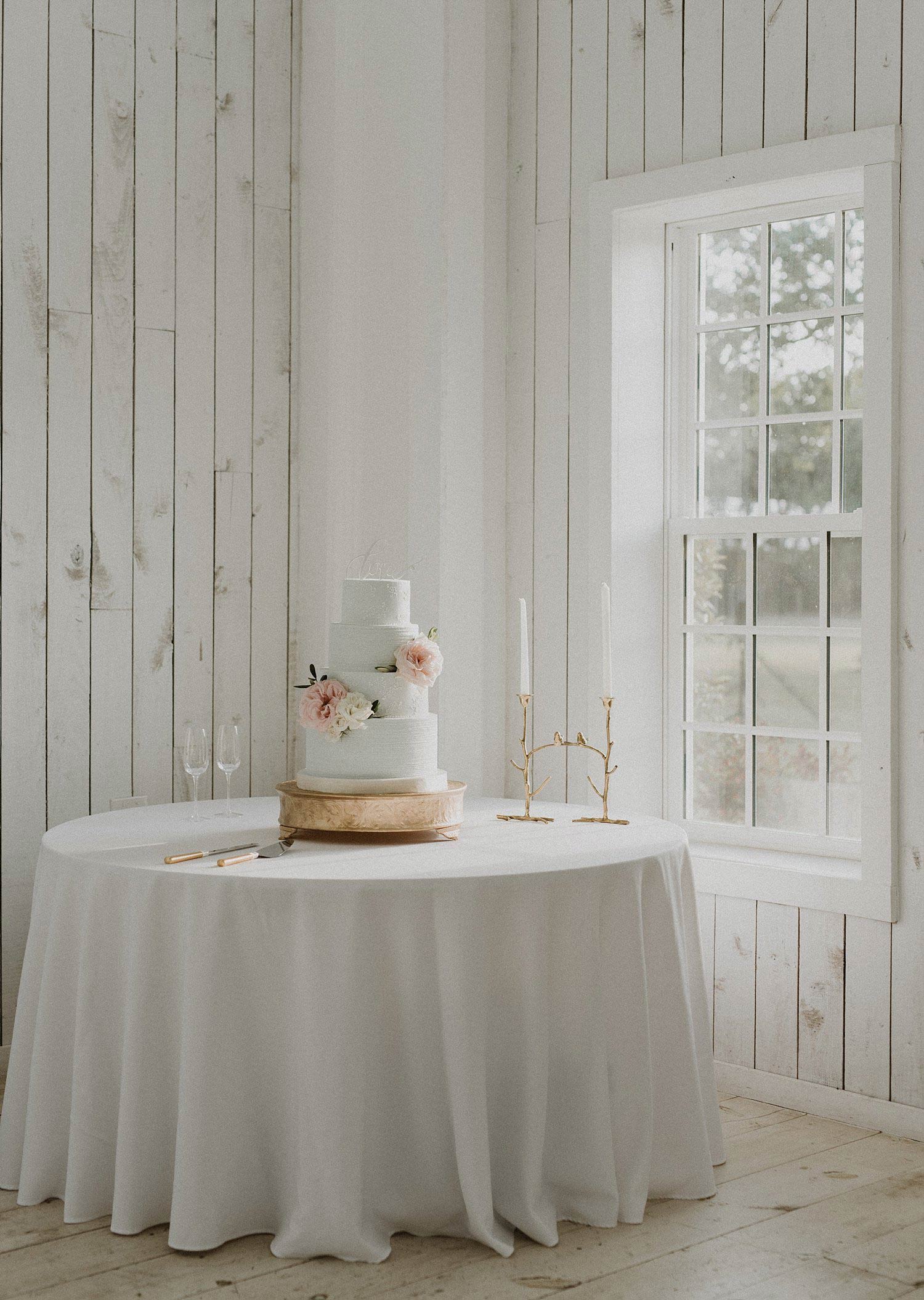 White Sparrow Barn dusty blue wedding cake on gold cake stand