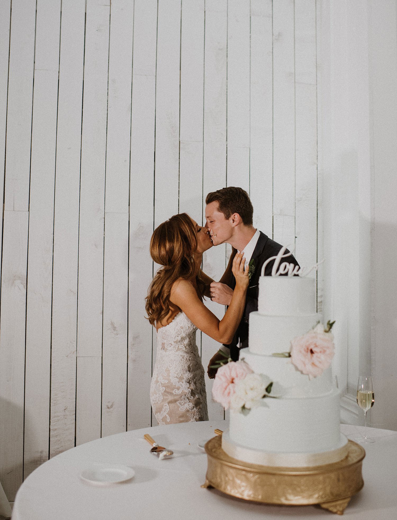 Bride and groom cutting wedding cake at white sparrow barn wedding