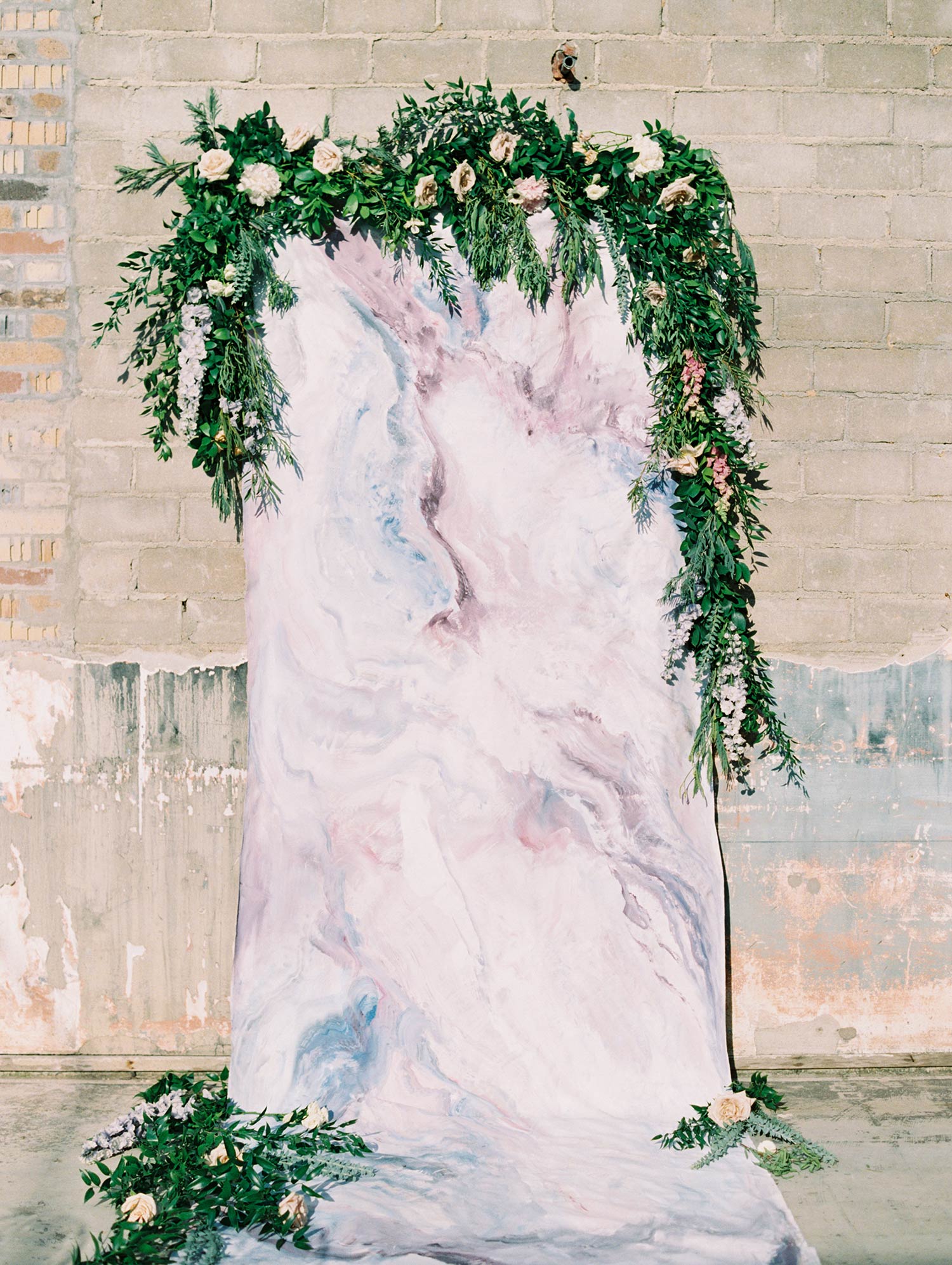 Marble moody backdrop for a wedding with greenery