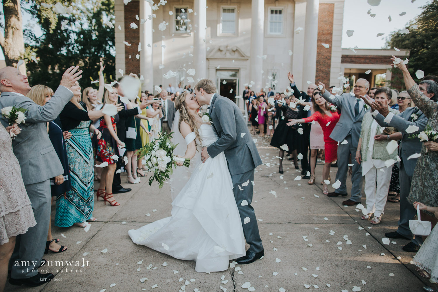 Bride and groom kissing at pedal exit