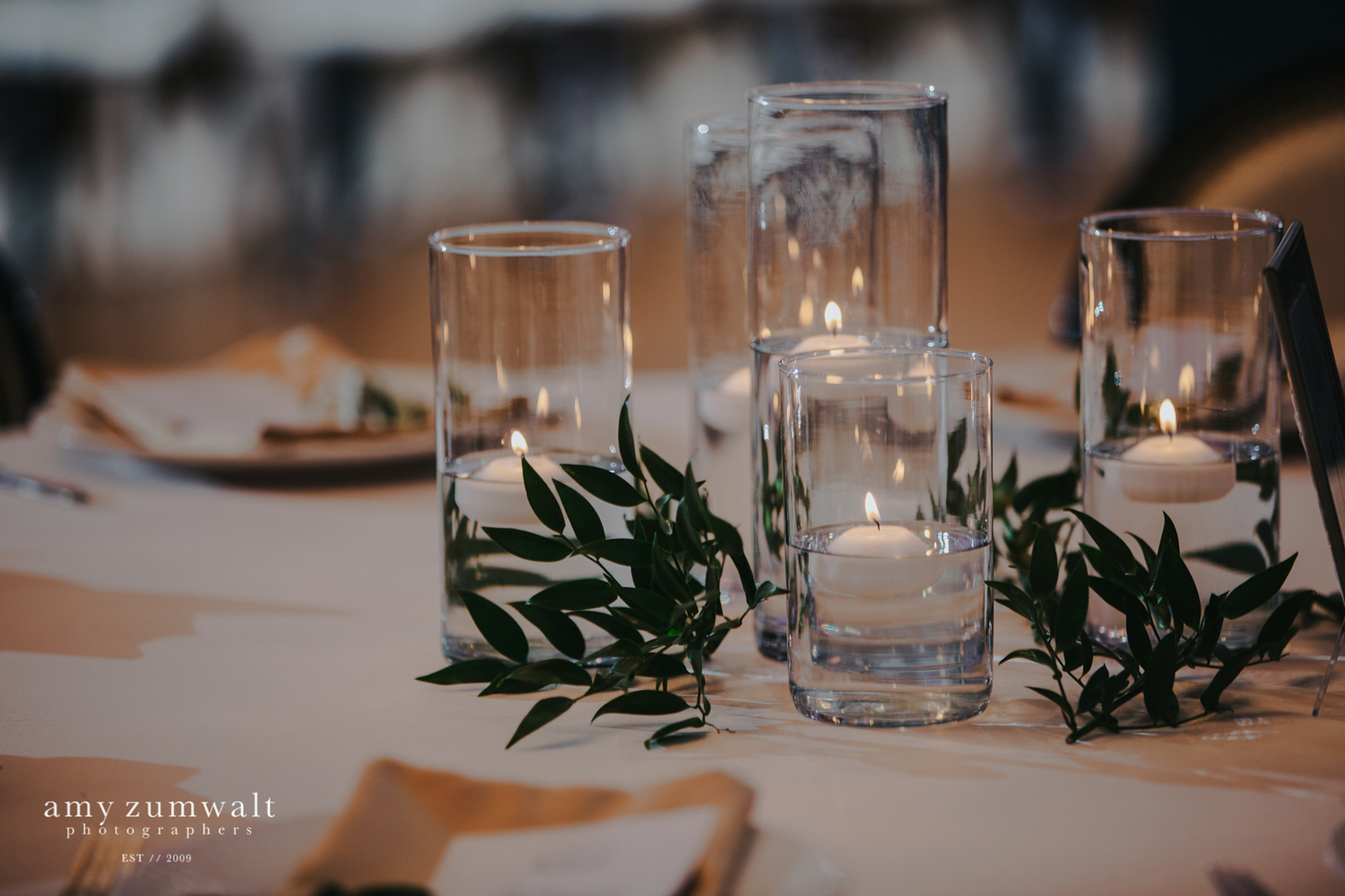 Candle centerpiece with greenery