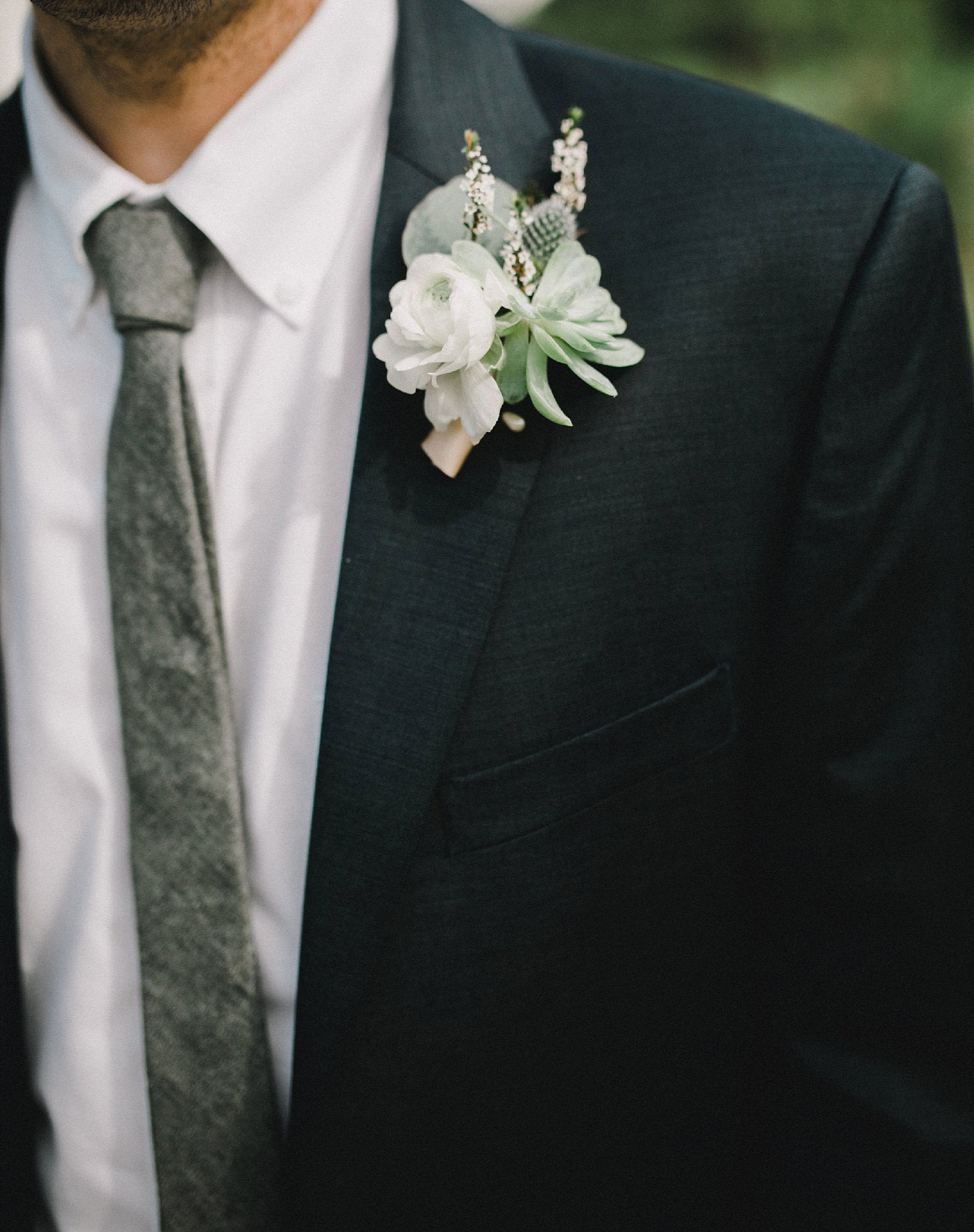 white ranunculus and succulent boutonniere