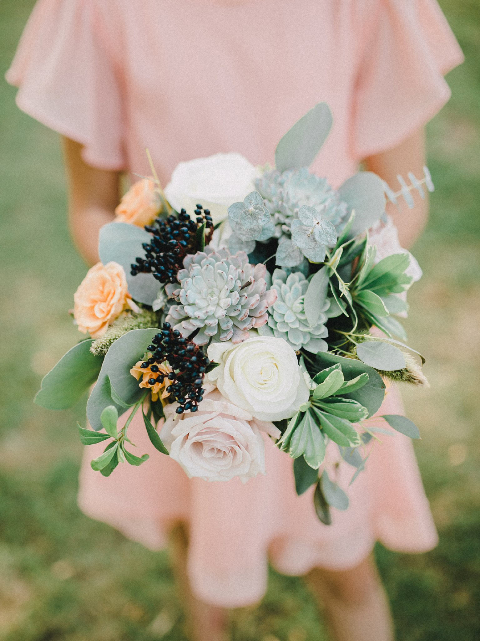 Navy, apricot, white, and green bridesmaid wedding bouquet
