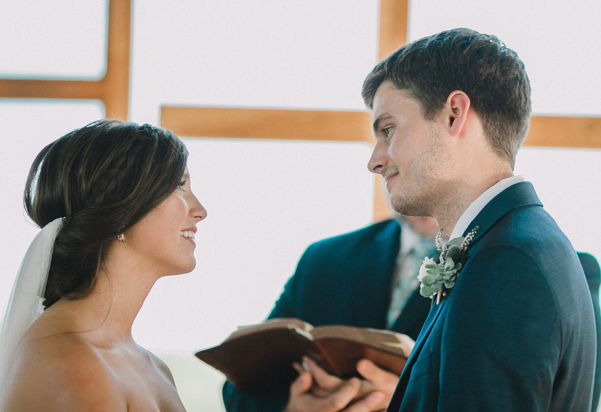 Bride and groom reading scripture during ceremony