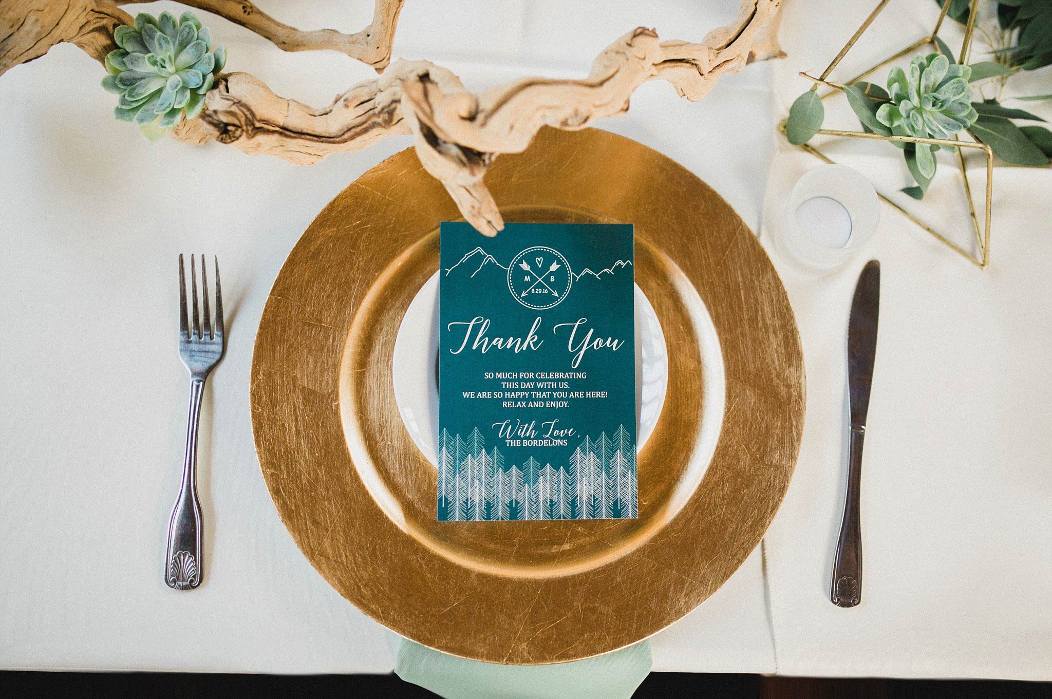 Gold chager place setting with driftwood and navy menu