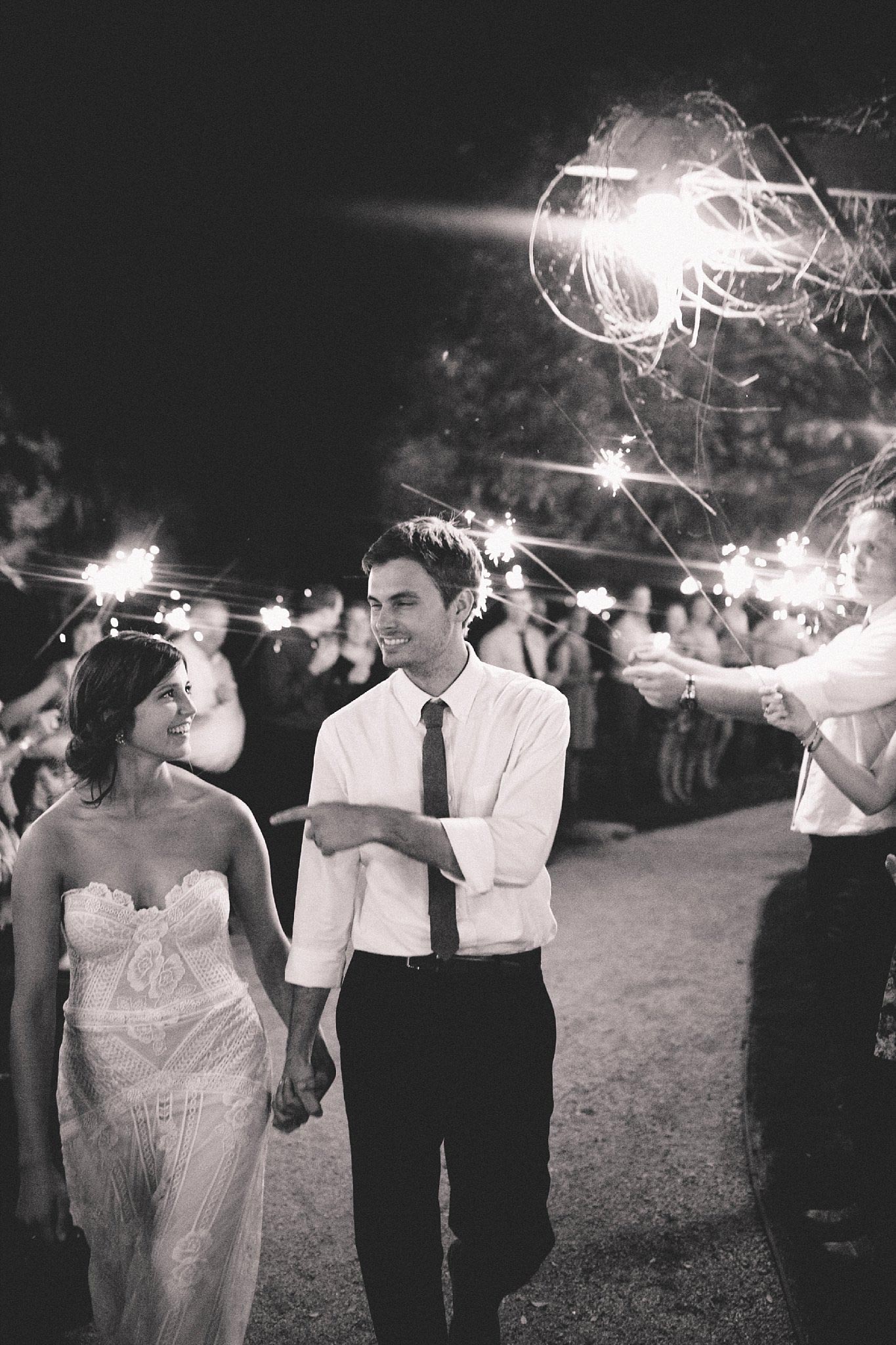 black and white picture of bride and groom exiting with sparklers